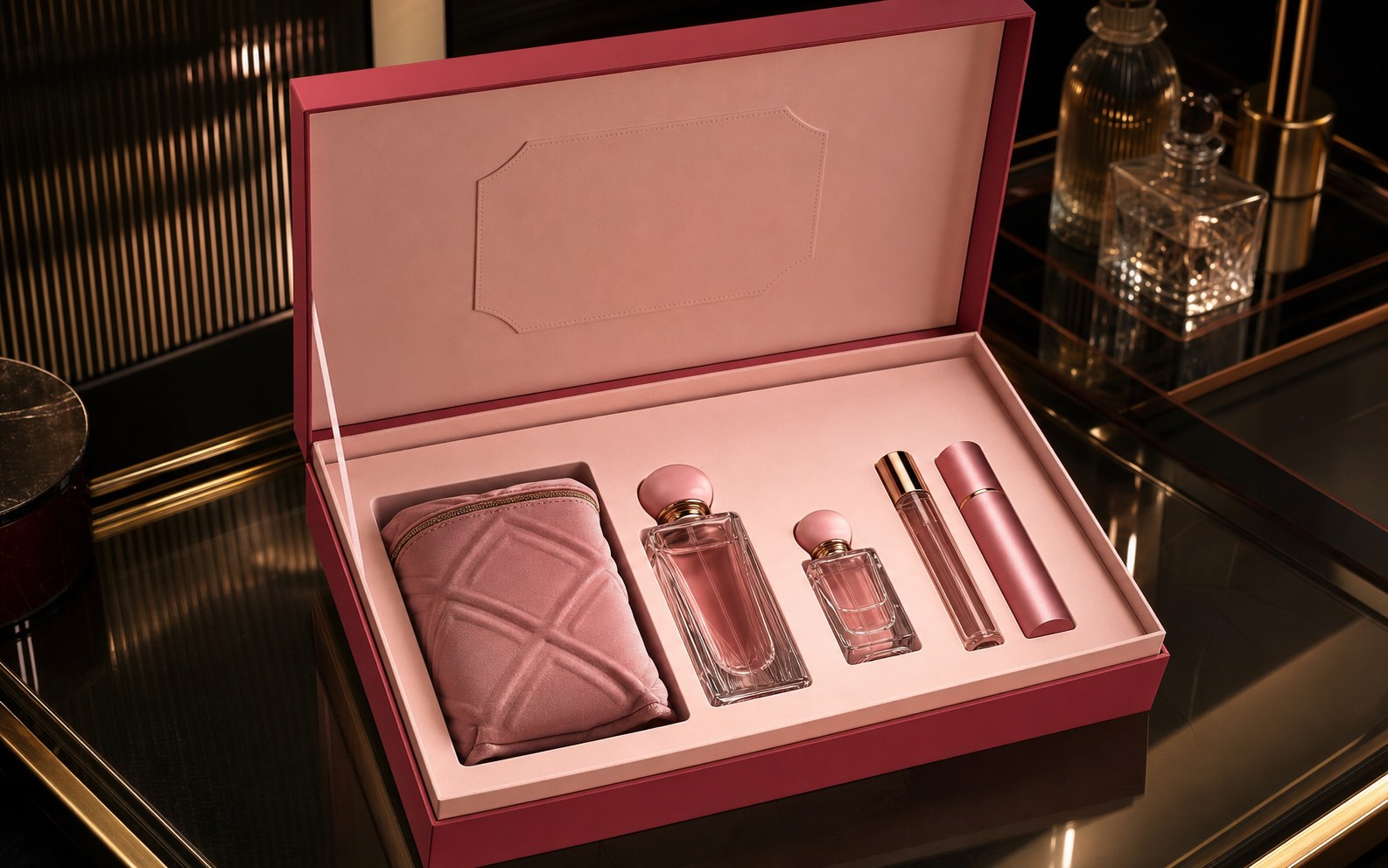 Luxury pink fragrance gift set displayed in an open rigid presentation box